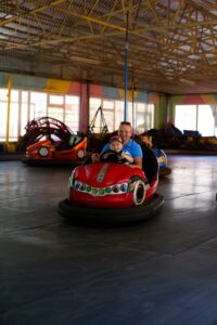 Celebrating your child's accomplishment at an amusement park. 